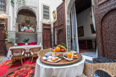 a table with fruit on it in a room at Riad Dar Cordoba in Fès