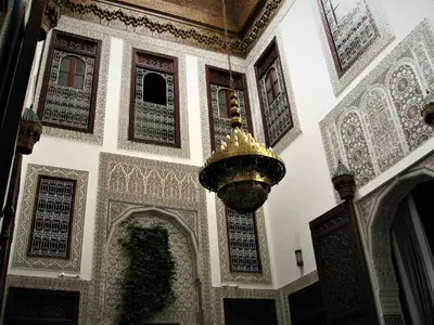a room with a chandelier and ornate walls and ceilings at Riad Dar Cordoba in Fès