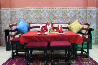 a dining room with a table with napkins on it at Hôtel Restaurant Dar Al Madina in Tinerhir