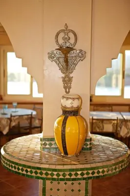 a yellow vase sitting on top of a table at Tigmi Dar Samy in Bine el Ouidane