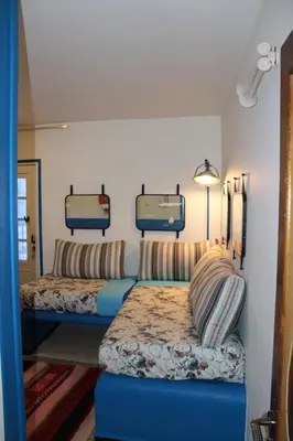 a bedroom with two beds and two trunks at Tigmi Dar Samy in Bine el Ouidane