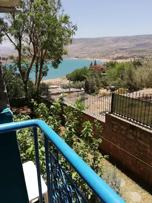 a balcony with a view of a lake at Tigmi Dar Samy in Bine el Ouidane