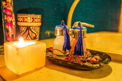 a candle and a plate of food next to a bowl of honey at Sirocco Luxury Camp in Merzouga