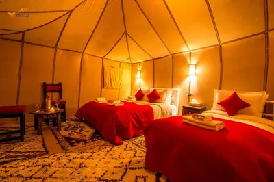 a bedroom with two beds in a tent at Sirocco Luxury Camp in Merzouga