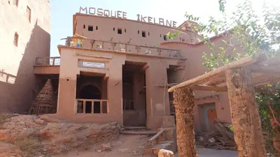 an old building with a sign on top of it at Riad iriki in Tinerhir