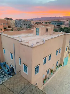 a view of a building with a sunset in the background at Riad iriki in Tinerhir