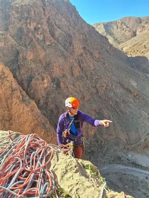a person standing on the side of a mountain at Riad iriki in Tinerhir