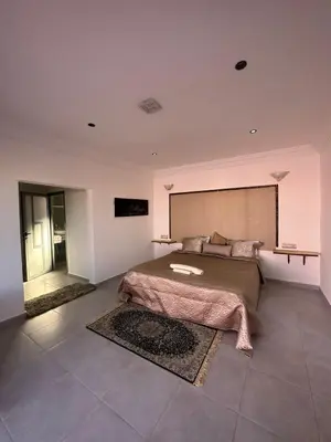 a bedroom with a large bed with a large wall at Maison d'hôtes La Ferme AZIZA in Fès