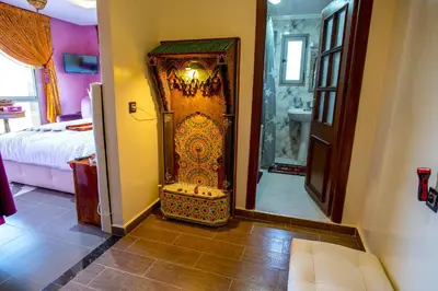 a room with an ornate door in a bedroom at Maison d'hôtes La Ferme AZIZA in Fès