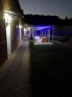 a night shot of a wedding venue with blue lights at Maison Duffal in Azrou