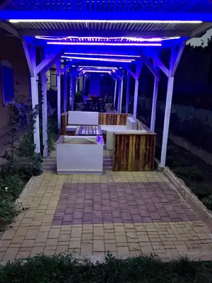 a pergola with blue lights on a patio at Maison Duffal in Azrou