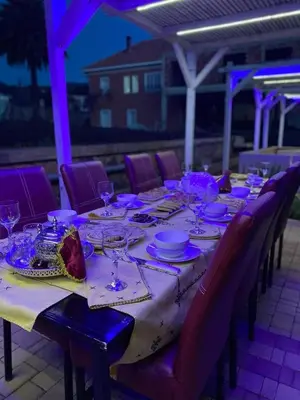 a long table with plates and glasses on it at Maison Duffal in Azrou