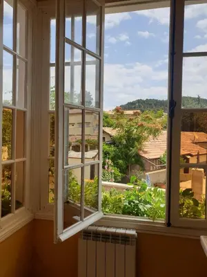 an open window with a view of a city at Maison Duffal in Azrou