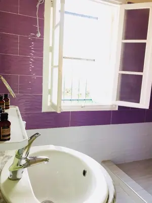 a bathroom with a sink and a window at Maison Duffal in Azrou