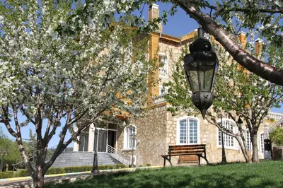 a bench in front of a building with a street light at Le Palais des Cerisiers in Azrou