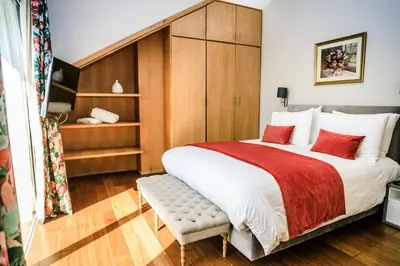 a bedroom with a large bed with red pillows at Le Palais des Cerisiers in Azrou