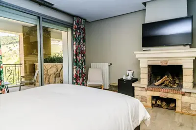 a bedroom with a bed and a fireplace at Le Palais des Cerisiers in Azrou