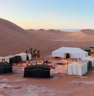 a group of tents in the desert at Camp atlantic chegaga in Mhamid