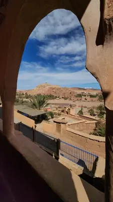 a view of a village from a stone archway at Dar Mouna in Aït Ben Haddou