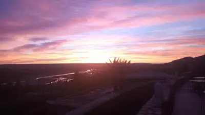 a sunset with the sun setting in the sky at Dar Mouna in Aït Ben Haddou