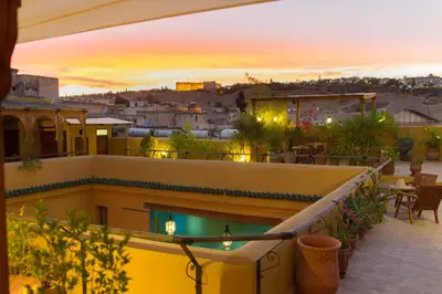 a balcony with a view of a city at sunset at Riyad Al Atik in Fès
