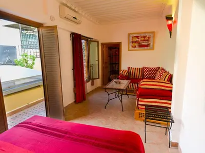 a living room with a couch and a table at Riyad Al Atik in Fès