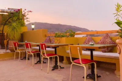a group of tables and chairs on a patio at Riyad Al Atik in Fès