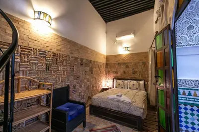 a bedroom with a bed and a sink in a room at Riad Hidaya in Fès