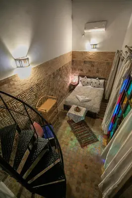 a view of a room with a bed and a staircase at Riad Hidaya in Fès