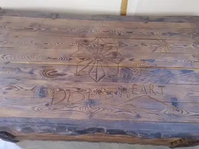 a wooden box with the words dead heart on it at Desert Heart Luxury Camp in Merzouga