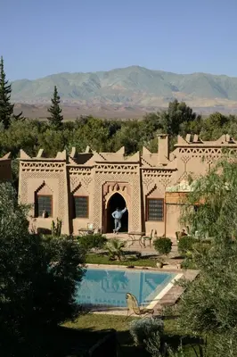 a building with a swimming pool in front of it at Sawadi Ecolodge in Skoura