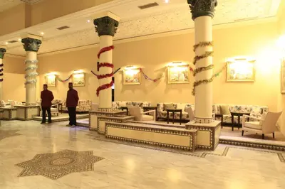 two people standing in a lobby with columns at Belere Arfoud in Erfoud