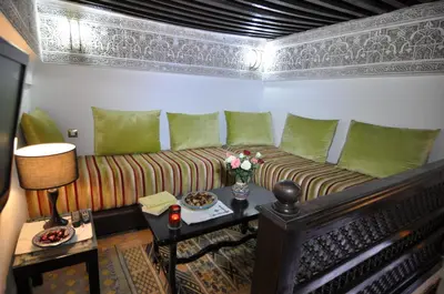 a living room with a couch and a table at Riad Adarissa in Fès