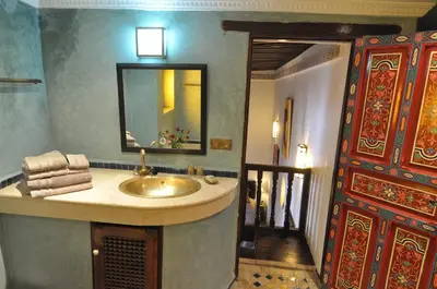 a bathroom with a sink and a mirror at Riad Adarissa in Fès