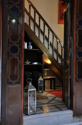 an open door with two lanterns next to a staircase at Riad Adarissa in Fès