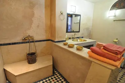 a bathroom with a tub and a sink at Riad Adarissa in Fès