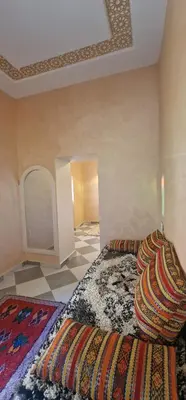 a room with a bed with a rug on the floor at Hiking Nomads Guesthouse in Tamellalt
