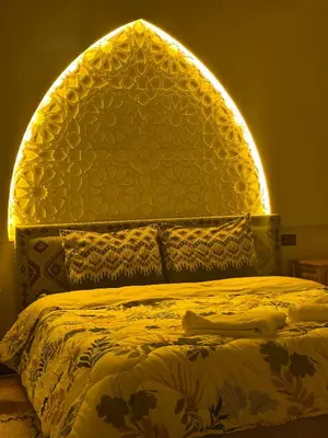 a bedroom with a large bed with an arch overhead at Hiking Nomads Guesthouse in Tamellalt