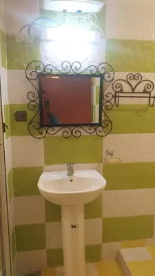 a bathroom with a sink and a mirror at Auberge Camping BOUGAFER Tamtetoucht in Tamtetoucht