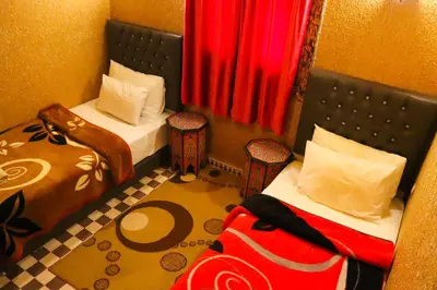 a small room with two beds and two chairs at Dar Diafa Kaltom in Ouzoud