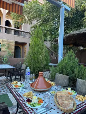 a table with food on top of a patio at Dar Diafa Kaltom in Ouzoud