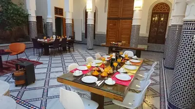 a table with plates of food on it in a room at Riad jasmins & Spa in Fès