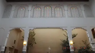 a room with a wall with stained glass windows at Riad jasmins & Spa in Fès