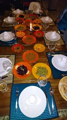 a wooden table with plates of food on it at Riad jasmins & Spa in Fès