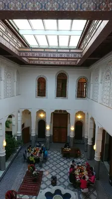 a group of people sitting on couches in a building at Riad jasmins & Spa in Fès