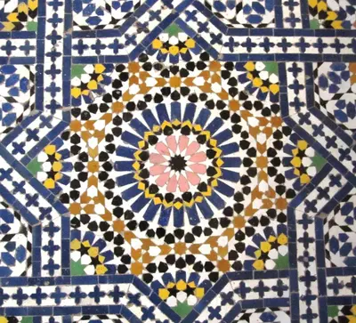 a close up of a tile floor with a flower pattern at Riad Jaouhara in Fès