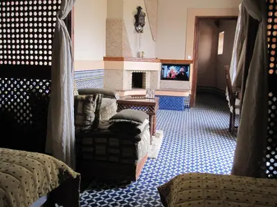a living room with a couch and a fireplace at Riad Jaouhara in Fès