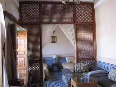 a living room with a couch and a bed at Riad Jaouhara in Fès