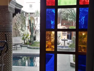 a view through a window of a courtyard with a pool at Riad Jaouhara in Fès