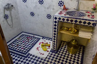 a small bathroom with a toy shower with a sink at Riad Lalla Fatima in Fès